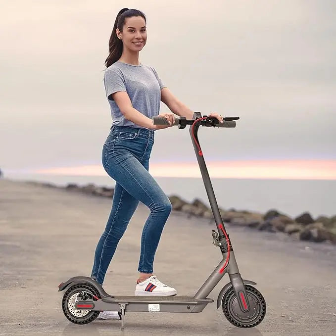 Woman riding an electric scooter on a beach